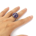 Detailed view of handmade tree of life ring with faceted round amethyst on finger - Purple Crystal