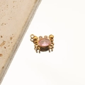 Macro shot of gold crab pendant with pink gemstone and crystal eyes on stone background - 6# Crab Pink Zircon