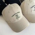 Detailed embroidery of 'FORGETSADNESS' and 'B' on a beige cotton baseball cap - Khaki
