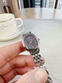 Detailed macro view of an oval silver metal watch with dark gray dial and link bracelet - Silver Black Dial