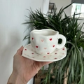 Handcrafted ceramic cup and saucer set featuring red heart pattern on white surface - Pink Heart Cup & Saucer
