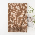 Brown faux cashmere scarf with white floral patterns and tassel trim, flat lay view - Coffee Background White Floral