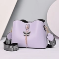 Minimalist purple bucket bag with golden butterfly charm and woven chevron strap - Purple