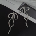 Detail of silver metallic bow earrings with long tassels and polished finish - Bowknot Long Ribbon Earrings (Silver)