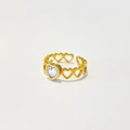 Macro shot of 18k gold plated stainless steel heart ring with green zircon stones - Adjustable Open / Clear