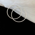 Dettaglio macro di orecchini a cerchio argento con texture satinata fine e scintillante - Large (6#) / Argento