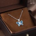 Elegant silver butterfly pendant necklace with deep blue sparkling wings and center crystal - Butterfly