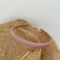 Pink fabric headband with a sleek satin finish displayed on a straw hat - Pink