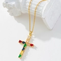 Gold plated cross necklace featuring colorful cubic zirconia on an elegant white pedestal - Gold/Colorful Zirconia Cross/Q
