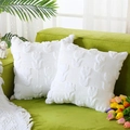 Set of two white knitted pillow covers with embossed tulip patterns on a green sofa - 18x18 Inch / White Tulip