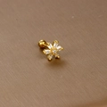 Macro shot of gold snowflake stud earring with baguette-cut zircons and ball back - Baguette Zirconia Snowflake / Gold