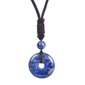 Detailed view of deep blue lapis lazuli donut pendant with a brown braided rope cord - Lapis Lazuli Necklace