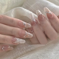 Close-up of nude oval press-on nails featuring a butterfly design and rhinestone chains - By1568 Exquisite And Translucent / Glue Type