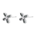 Detail of silver bow earrings set with vibrant green cubic zirconia on a white background - Platinum Green Zirconia