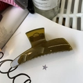 Detail view of large olive green translucent hair claw clip with non-slip grip teeth - Jelly Yellow Green