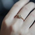 Exquisite vintage halo diamond ring with petal pavé band on a model's hand - Adjustable Open / Gold