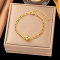 Elegante pulsera de eslabones cubanos dorados con cuenta central pulida y cierre de langosta - Cadena Cubana con una Sola Cuenta de Acero (E210) / Dorado