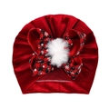 Red velvet baby turban hat with a red and black plaid bow and a white fluffy pompom - Red