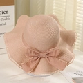 Summer straw sun hat in lotus pink with wide wavy brim and elegant ribbon bow detail - Lotus Knot Pink