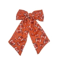 Detail of an orange hair bow clip featuring American football prints and long ribbons - Orange Football