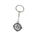 Close-up of vintage silver compass keychain with engraved N/S/E/W directional markings - Compass Style