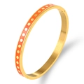 Gold stainless steel bangle featuring orange enamel finish and delicate golden polka dots - Gold with Orange Enamel and Gold Dots