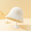 Minimalist white faux fur bucket hat displayed on a stand with a soft cream texture - M (56-58cm) / White