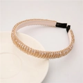 Detailed shot of champagne beaded baroque headband on white ceramic tray - Champagne