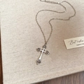 Gothic silver cross necklace with intricate filigree on a vintage chain over card - Vintage Hollow Pattern Cross Pendant Necklace
