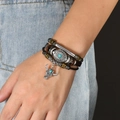 Close-up of a vintage leather layered bracelet with turquoise beads and a bull head charm - Bull Head Turquoise Pendant Style (手链：款式五)