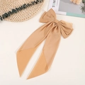 Detail of vintage gold bow hair clip with elegant long ribbons on a minimalist background - Brown
