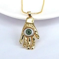 Golden Hamsa hand necklace with green evil eye pendant and beaded chain on white background - Green