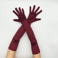 Dettaglio di guanti lunghi in raso bordeaux con texture liscia effetto seta per feste - Taglia unica / Rosso Scuro