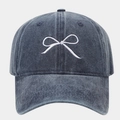 Detailed close-up of white bow embroidery on washed denim cotton baseball cap texture - Adjustable / Navy Blue
