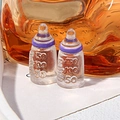 Macro detail of two miniature resin baby bottles with purple caps and scale markings - Purple