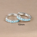 Macro shot of 10mm silver hoop earrings featuring sky blue turquoise zircons - 10mm / Silver (Blue Zirconia)