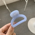 Detail of light blue resin hair claw clip with a transparent finish and arc design - Sky Blue