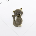 Close-up of vintage bronze cat charm with detailed texture and black eyes for DIY crafts - Antique Bronze