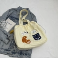 Beige canvas tote bag with embroidered cat dog graphics and navy patch pocket - Three Animals Patch