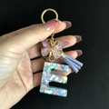 Detail of purple resin letter E keychain with gold butterfly and heart sequins - Letter E / Butterfly Tassel 8-Shape Buckle