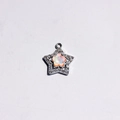 Macro view of alloy star pendant with macaron flower opal and sparkling zircon inlay - Orange