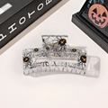 Detail of square hollow hair claw with black spider web and orange cross patterns - 8.5cm Transparent Square - Spider Webbing