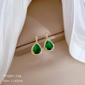 Detailed macro view of teardrop green zircon earrings with golden metal and white stones - Waterdrop Green Zirconia Stud Earrings (C124)