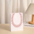 Close-up of white baseball gift bag with red stitching on a wooden tabletop - White Baseball Stitching Style