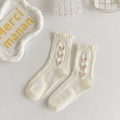 Close-up of cream white mid-calf socks with frilly lace edges and pink bow embroidery - Cream Multiple Pink Bows