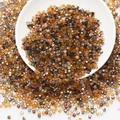 Macro view of assorted amber and brown square glass beads for DIY jewelry making - Coffee Colors