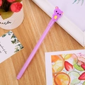 Purple cartoon neutral pen featuring a cute 3D bear topper on a wooden desk setting - Patch Bear Purple