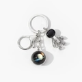 Detail of silver astronaut keychain with planetary pendant and secure lobster clasp - Yellow Astral (10)
