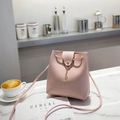 Minimalist pink bucket bag for women featuring a cute golden deer charm decoration - Pink