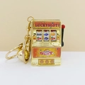Golden mini slot machine keychain with working handle and a matching bell charm - Gold Gradient Textured Sticker With Gold Clasp And Bell / 1000 Minimum Order